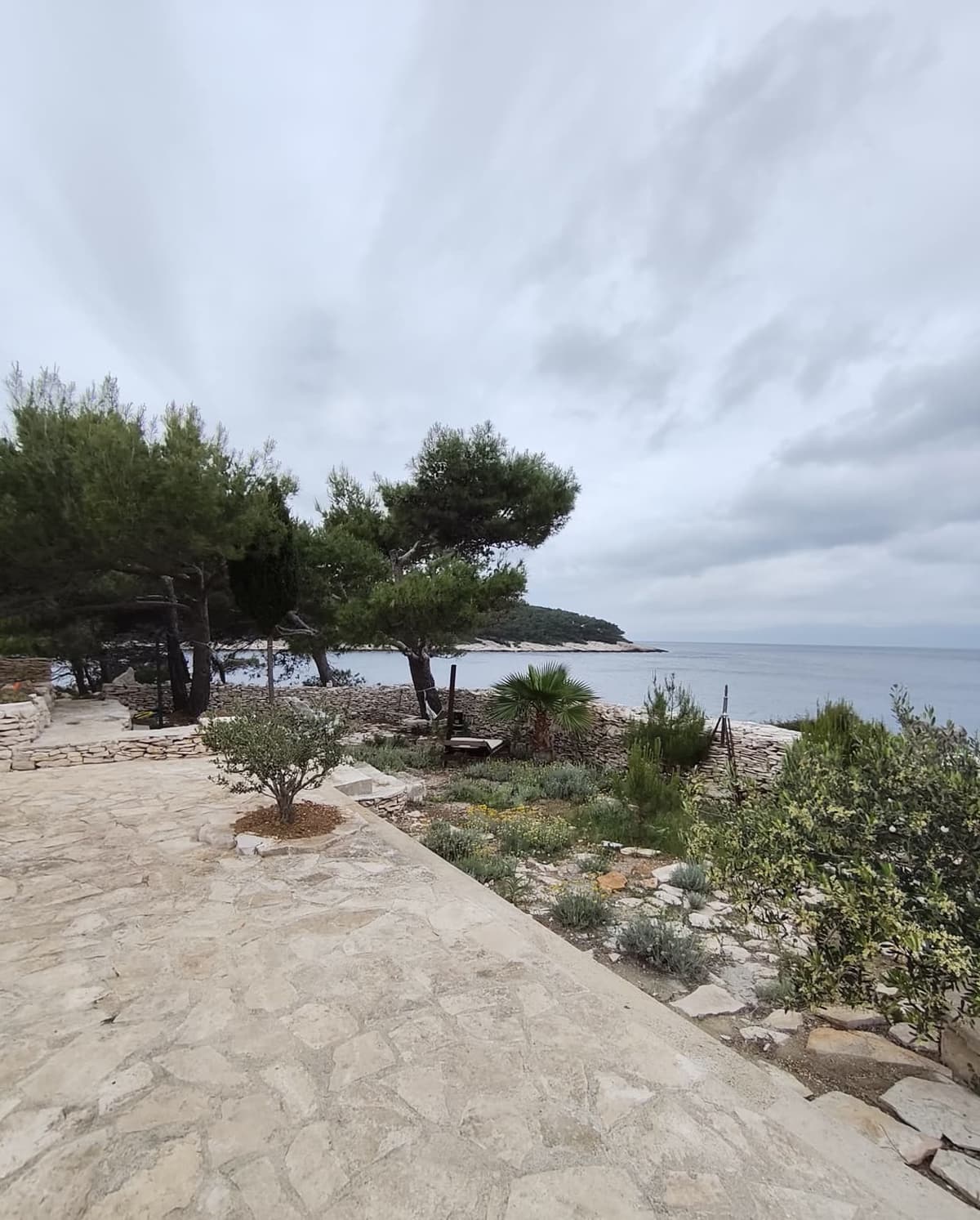 Large garden meeting the rocky shoreline