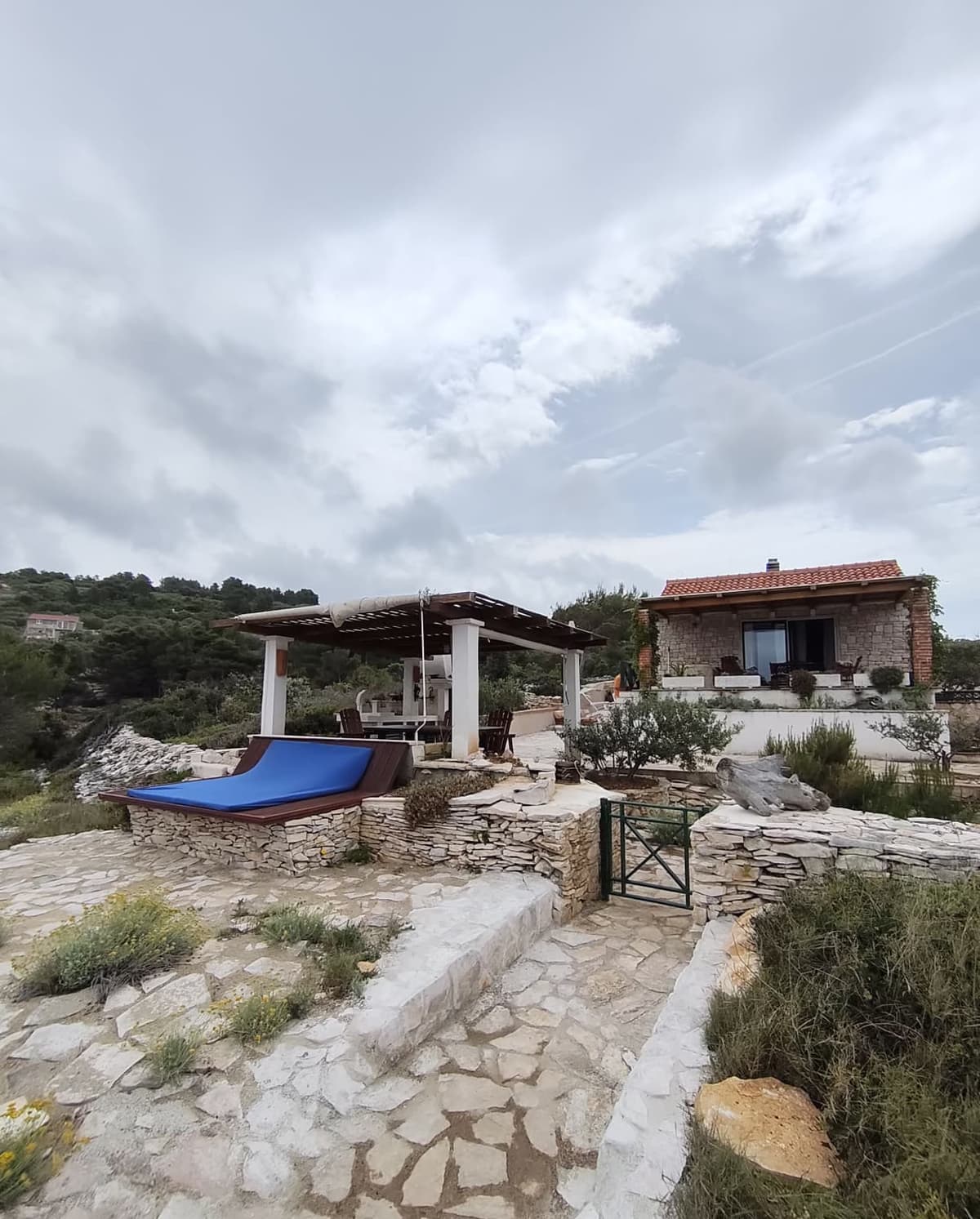 Sun lounger overlooking the house and pergola