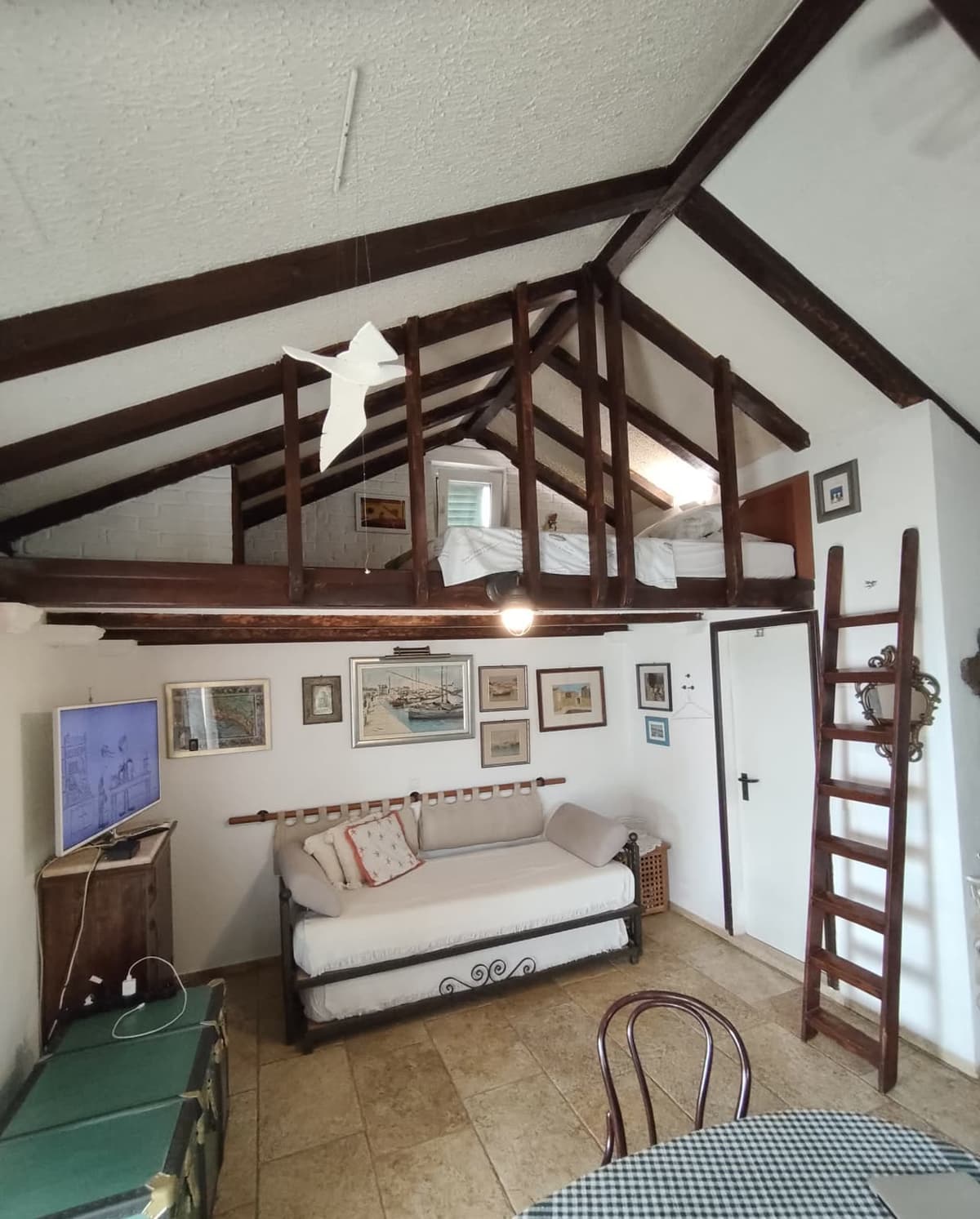 Living area with daybed and loft ladder